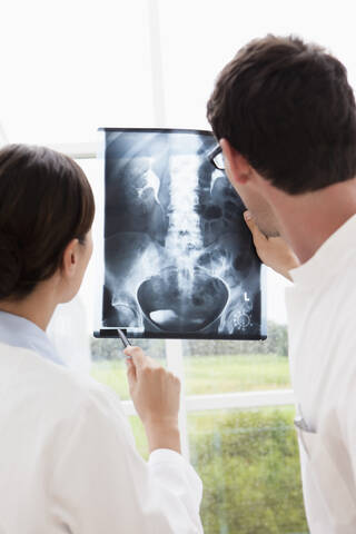 Germany, Bavaria, Diessen am Ammersee, Two young doctors examining x-ray, smiling stock photo