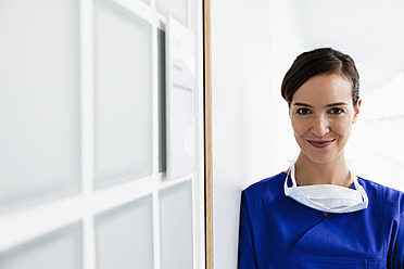 Germany, Bavaria, Diessen am Ammersee, Young doctor in scrubs, smiling, portrait - JRF000254