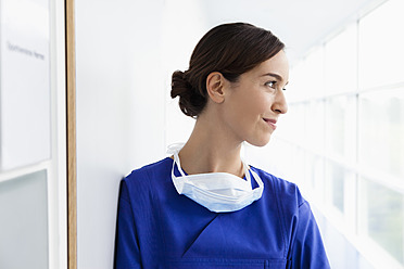 Germany, Bavaria, Diessen am Ammersee, Young doctor in scrubs, smiling - JRF000255