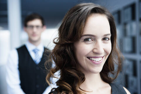 Germany, Bavaria, Diessen am Ammersee, Close up of businesswoman standing in front of businessman, smiling stock photo