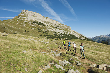 Austria, Kleinwalsertal, Group of people hiking on mountain trail - MIRF000221