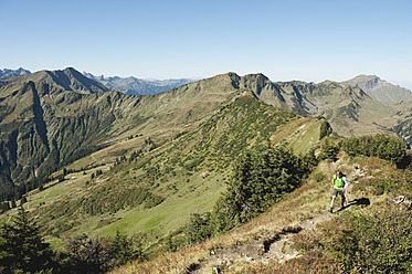 Austria, Kleinwalsertal, Mid adult man hiking on mountain trail - MIRF000265