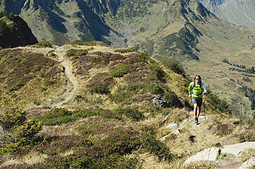 Austria, Kleinwalsertal, Mid adult man hiking on mountain trail - MIRF000268