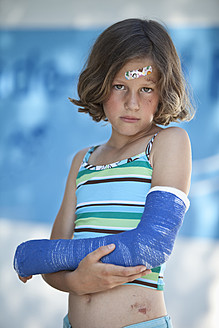 Germany, Bavaria, Wounded girl in swimwear and with broken arm, portrait - MAEF003586