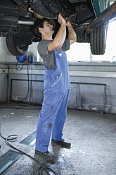 Germany, Ebenhausen, Mechatronic technician working in car garage - TCF001637
