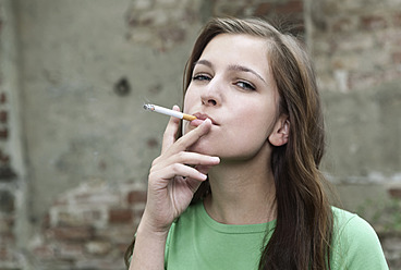 Germany, Berlin, Close up of young woman smoking, portrait - WESTF016928