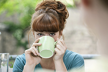 Deutschland, Berlin, Nahaufnahme einer jungen Frau beim Kaffeetrinken - WESTF016936