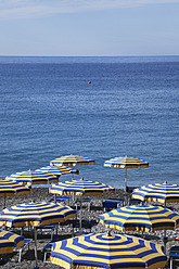 Italy, Liguria, Cinque Terre, Deiva Marina, View of parasol and sunbeds on beach of Mediteranean Ocean - GWF001554