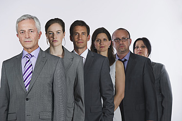 Business people standing in row against white background - WESTF016997