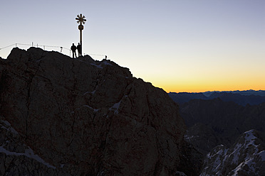 Germany, Bavaria, Bavarian Alps, Wetterstein, View of cross on summit of Zugspitze at dawn - FOF003577