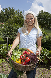 Germany, Bavaria, Altenthann, Woman with basket full of vegetables - RBF000707