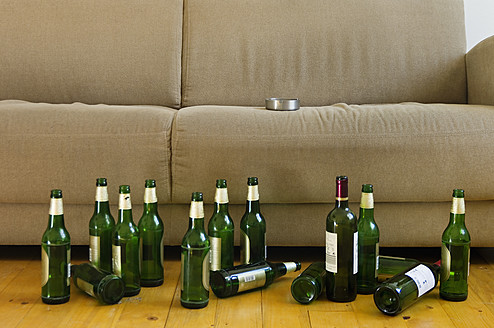 Germany, Hessen, Frankfurt, Sofa with empty beer bottles - MUF001042