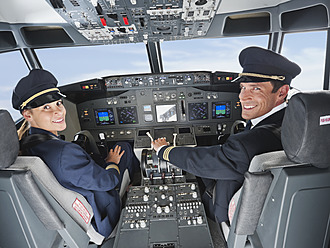 Germany, Bavaria, Munich, Pilot and co-pilot piloting aeroplane from airplane cockpit - WESTF017042