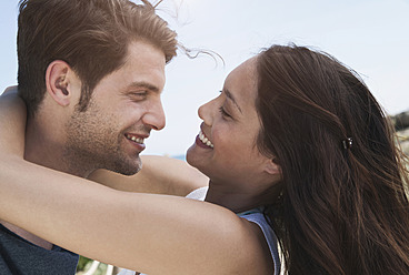 Spain, Majorca, Young couple romancing on boardwalk, close up - WESTF017125