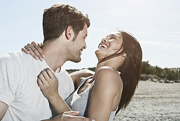 Spain, Majorca, Young couple kissing each other, smiling - WESTF017144