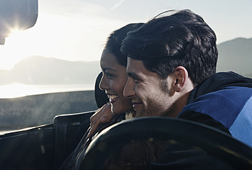 Spain, Majorca, Young couple sitting in cabriolet car, close up - WESTF017167