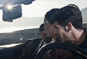 Spain, Majorca, Young couple sitting in cabriolet car, close up - WESTF017168