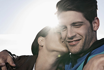 Spain, Majorca, Young woman kissing man in cabriolet car, close up - WESTF017170