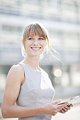 Germany, Bavaria, Munich, Young businesswoman with digital tablet - MAEF003732