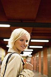 Germany, Bavaria, Munich, Young woman in metro station, smiling, portrait - SPOF000007