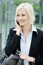 Germany, Bavaria, Munich, Young woman on phone, smiling - SPOF000029