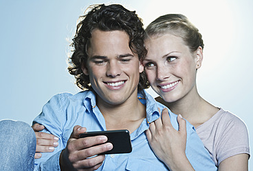 Italy, Tuscany, Close up of young couple, man using cell phone - PDF000280
