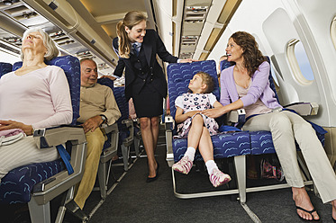 Germany, Munich, Bavaria, Passengers with stewardess in economy class airliner - WESTF017253