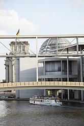 Germany, Berlin, People in ferry boat passing by Parliament Building - JMF000029