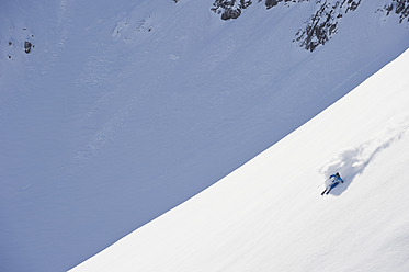 Austria, Zurs, Lech, Young man doing alpine skiing on Arlberg mountain - MIRF000286