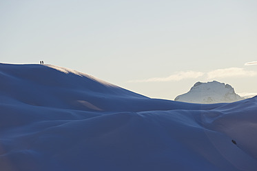 Austria, Zuers, Telemark skiers walking in Arlberg mountain snow - MIRF000333