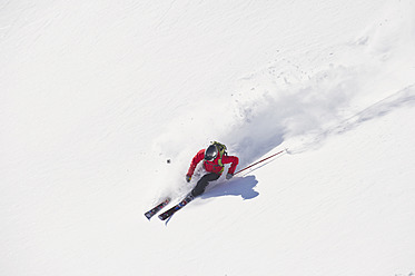 Austria, Zuers, Young man doing telemark skiing on Arlberg mountain - MIRF000336