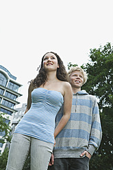 Germany, Berlin, Teenage couple on city street - WESTF017538