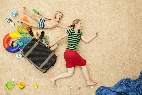 Germany, Mother and son with toys and baggage at beach - BAEF000296