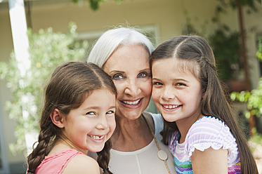 Germany, Bavaria, Granddaughters and grandmother smiling, portrait - WESTF017734