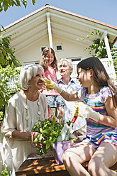 Germany, Bavaria, Family gardening together, smiling - WESTF017742