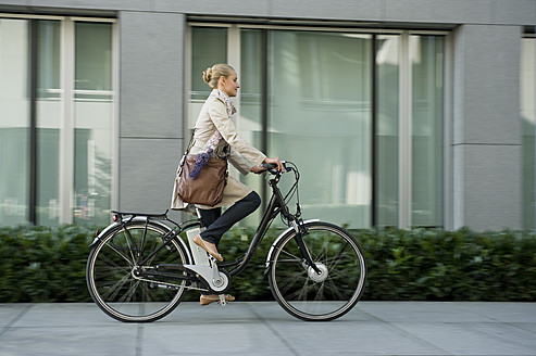 Germany, Bavaria, Teenage girl riding bicycle - RNF000678