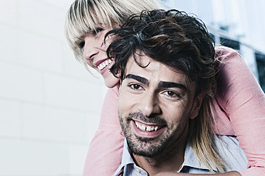 A happy young couple in Cologne, Germany, captured in a close-up shot with beaming smiles - WESTF017984