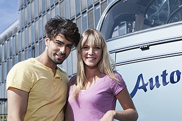 A happy young couple poses for a portrait in Cologne, Germany - WESTF018001