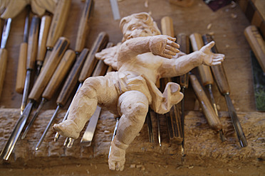 Statue in Holzschnitzerwerkstatt in Oberbayern, Deutschland, wird mit Meißel bearbeitet - Nahaufnahme - TCF001958