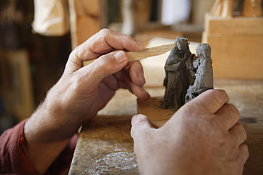 Close-up of a skilled craftsperson carving a statue in Upper Bavaria, Germany - TCF001972