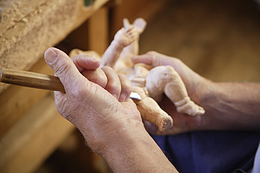 Close-up of a skilled craftsperson carving a statue in Upper Bavaria, Germany - TCF001978