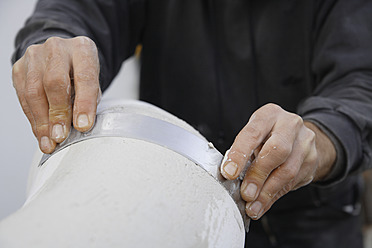 A sculptor in Schaeftlarn, Upper Bavaria, Munich, Germany, working with gypsum to create beautiful art pieces - TCF001985