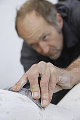 A sculptor in Schaeftlarn, Upper Bavaria, Munich, Germany, is seen working with gypsum to create their art - TCF001988