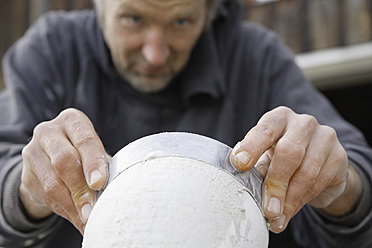 A sculptor in Schaeftlarn, Upper Bavaria, Munich, Germany, is seen working with gypsum to create art - TCF001989