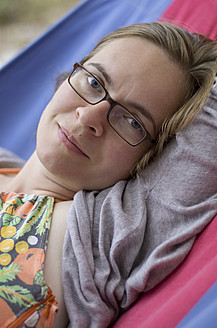 Serene mid-adult woman enjoying a peaceful moment on a hammock amidst the beautiful Ionian Islands in Greece - MUF001138