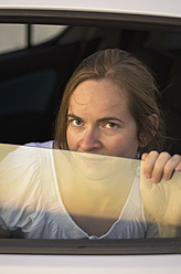 A happy woman enjoying the scenic drive through Ithaca, one of Greece's beautiful Ionian Islands - MUF001174