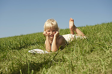 A peaceful moment in Bavaria as a young girl loses herself in a book, surrounded by the serene beauty of nature - RNF000748