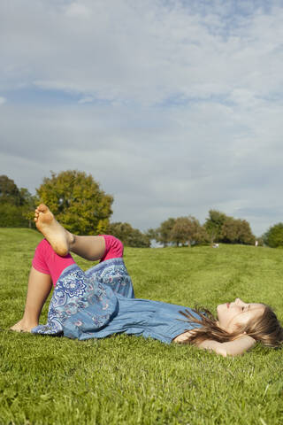 A peaceful scene of a Bavarian park where a young girl is enjoying the calmness of nature stock photo