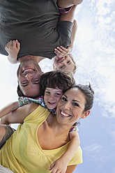 Experience unadulterated happiness in a Bavarian park as parents carry their kids on their backs, captured in a charming portrait - SKF000609