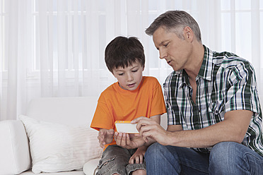 Father and son bonding over technology in Munich, Germany - SKF000659